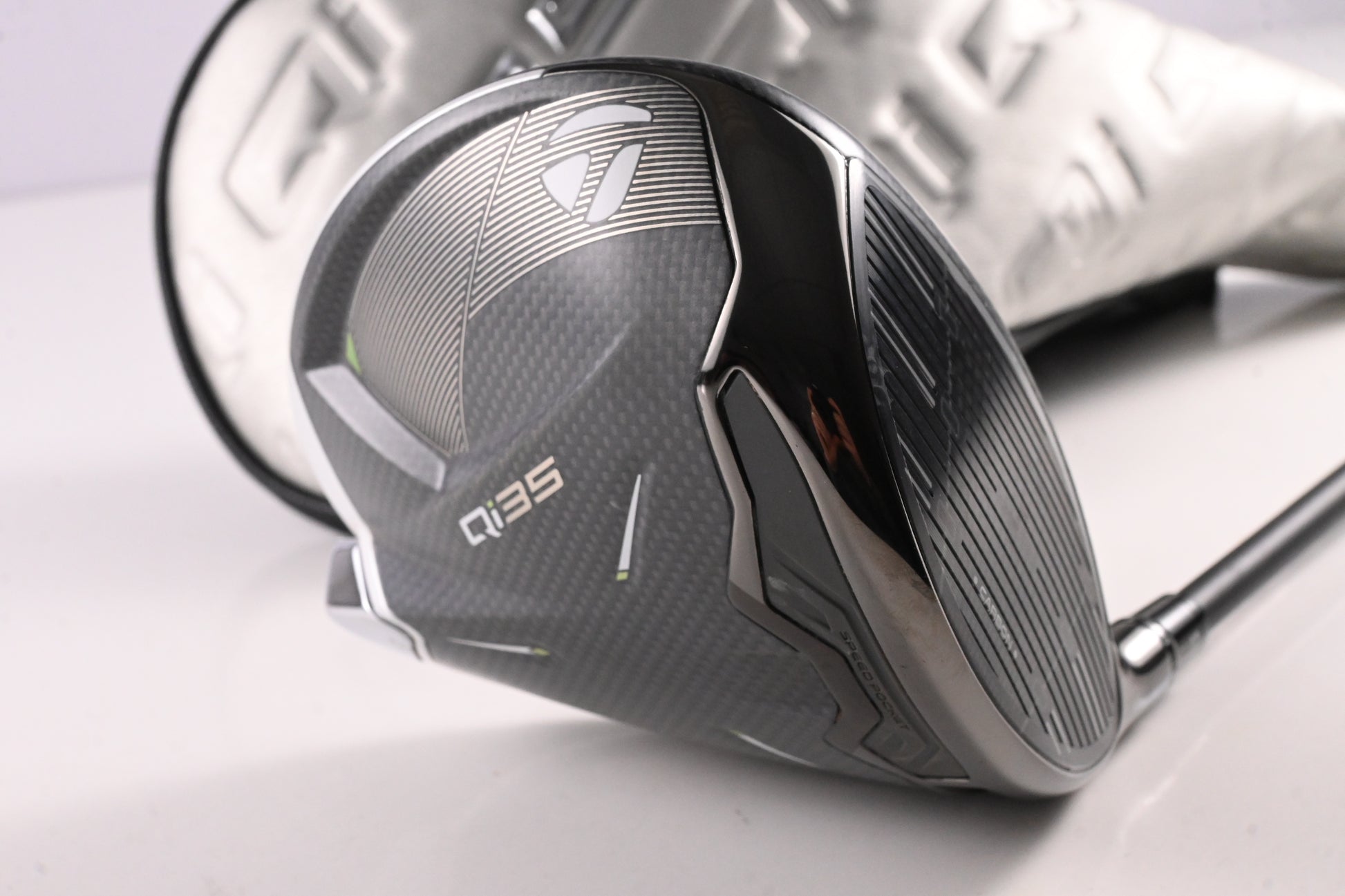 Close-up of a golf club head with 'Q35' branding on a light background