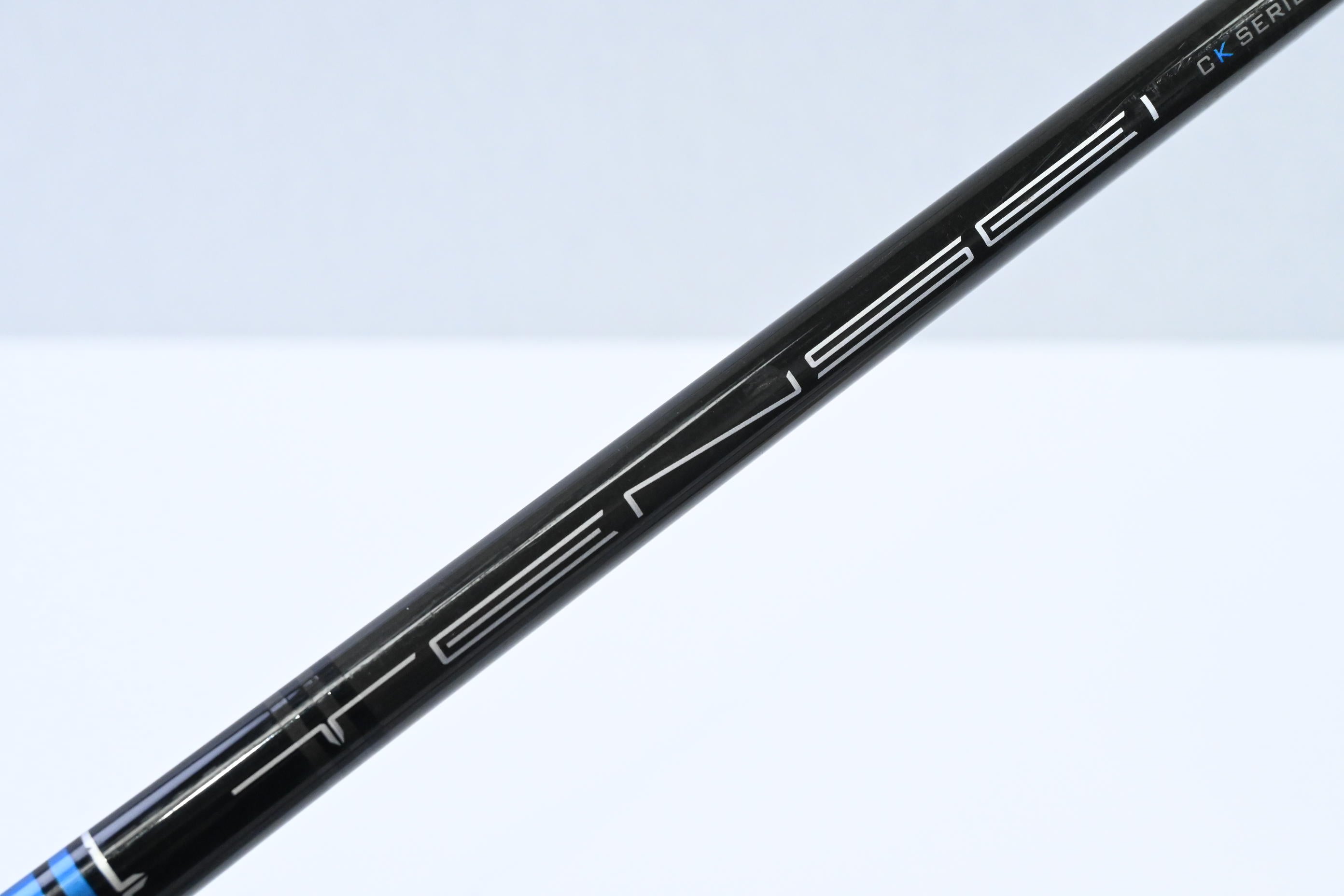 Golf club shaft with branding on a light blue background